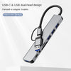 A silver USB-C and USB dual-head multiport hub with eight ports shown in a close-up view.