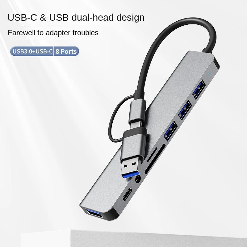 A silver USB-C and USB dual-head multiport hub with eight ports shown in a close-up view.