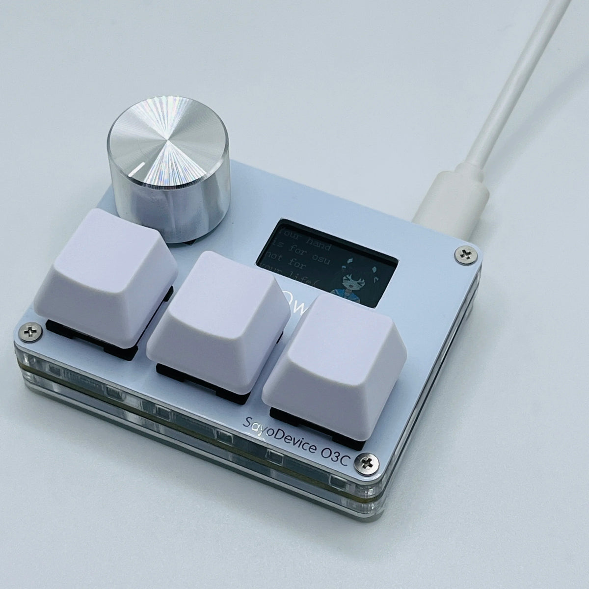 A close-up view of a light blue electronic device with a silver knob and several white switches.