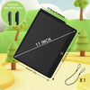 A black 11 inch interactive LCD writing tablet is shown with various pens and surrounding green trees.