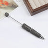 A silver pen accessory featuring a rhinestone beaded tip and a decorative sphere on a long metal shaft.