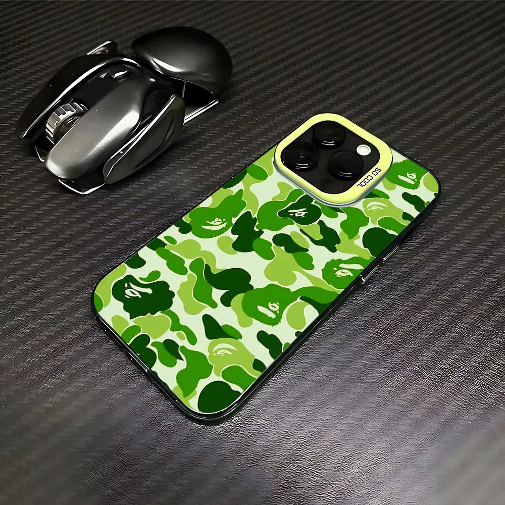 A green and camouflage patterned phone case lying next to a silver Apple AirPods case on a dark surface.