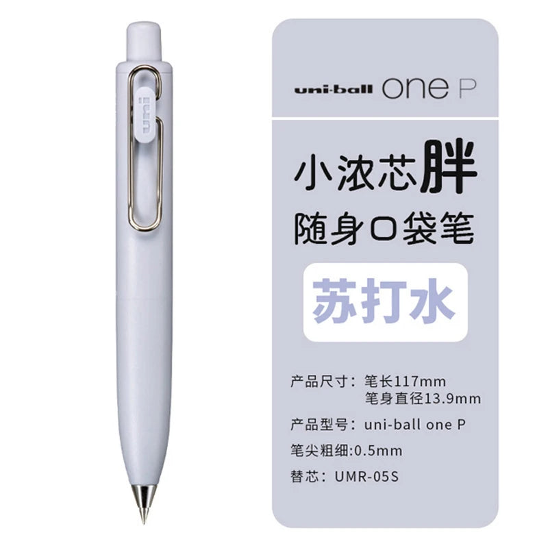 A white Uni-Ball One P pen is shown, featuring a gold clip and quick-dry ink.