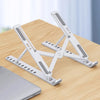 A white foldable adjustable laptop stand is shown resting on a wooden table.