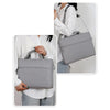 A woman is shown carrying a gray premium laptop sleeve for notebooks on her shoulder.