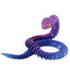 A purple and blue articulated 3D printed snake figurine with yellow eyes.