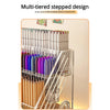 A multi-tiered stepped design acrylic desk organizer holding various pens, pencils, and art supplies.