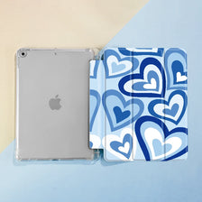 A clear case for an iPad featuring a blue and white heart pattern, with a separate slot for a pencil.