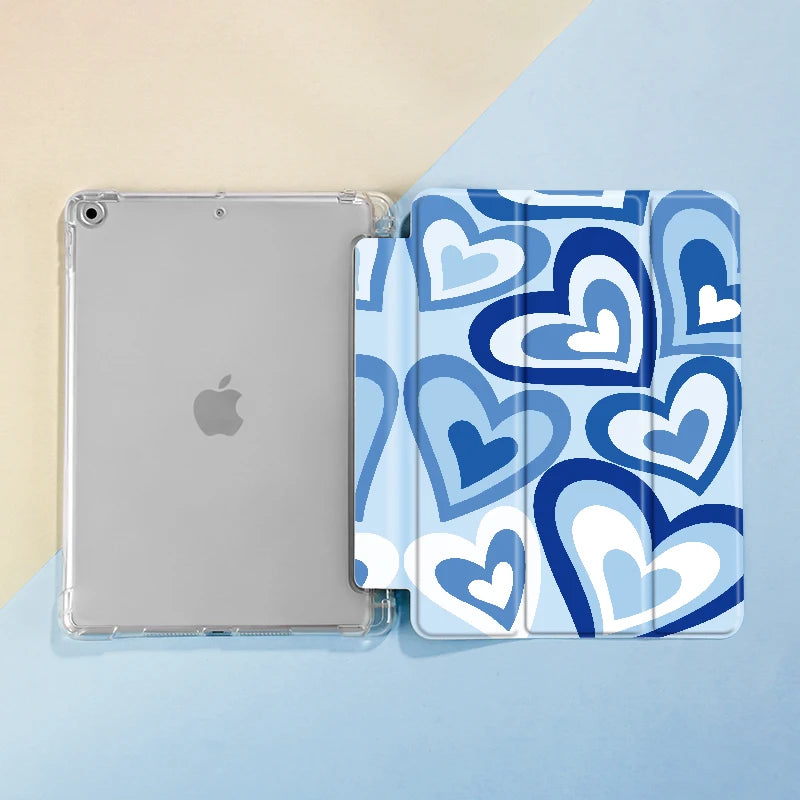 A clear case for an iPad featuring a blue and white heart pattern, with a separate slot for a pencil.