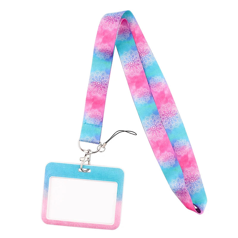 A pink and blue patterned fabric lanyard with a clear plastic tag attached for ID badges and accessories.