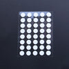 A clear plastic sheet containing 40 white adhesive glide feet for universal mouse skates.