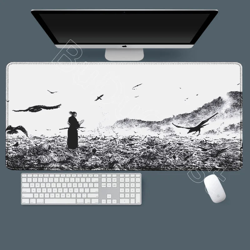 A large black and white manga-themed gaming mousepad is shown with a computer monitor, keyboard, and mouse.