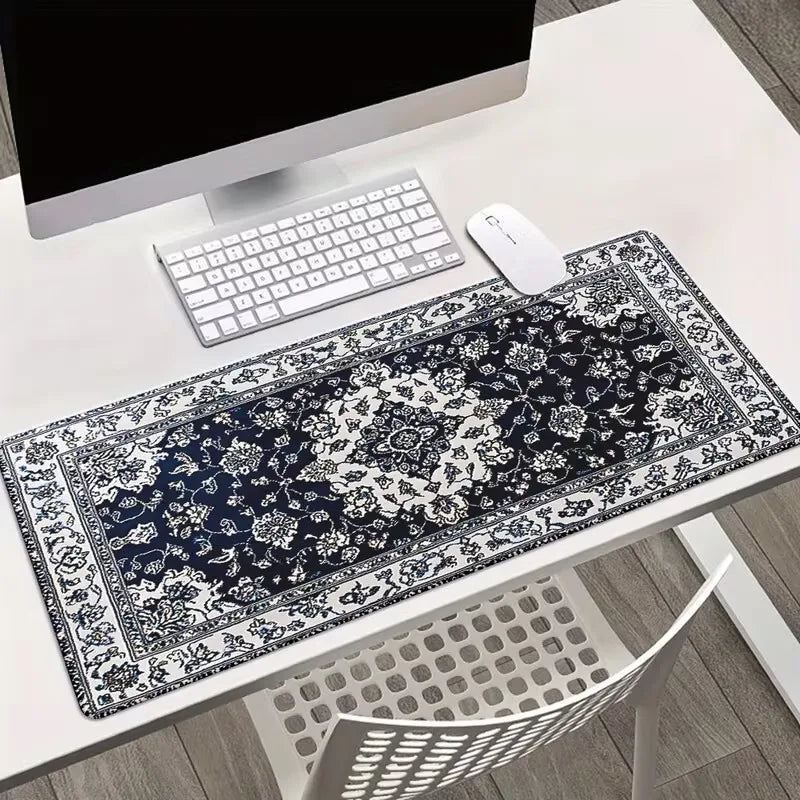 A vintage Persian rug patterned gaming mouse pad with a non-slip rubber base is displayed on a white desk.