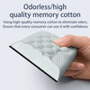 A hand holds a light green memory cotton wrist rest pad with a textured surface.