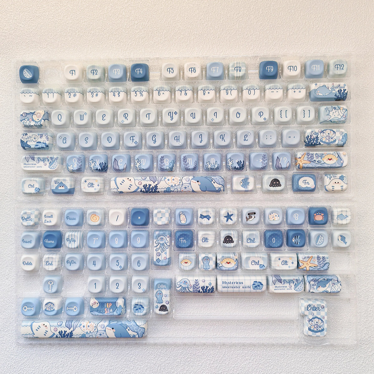 A collection of blue sea themed PBT keycaps for a mechanical keyboard.
