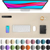 A large tan desk mat featuring various color circles for a laptop and keyboard setup.