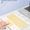 A hand is using a yellow keyboard case for an iPad on a marble surface.