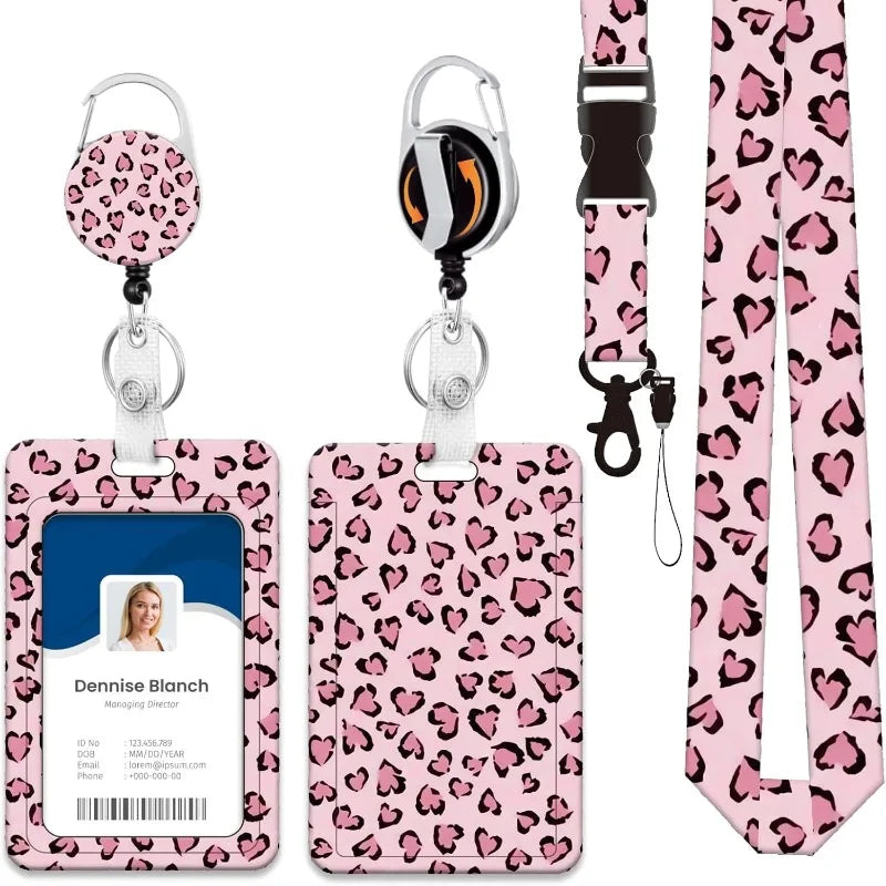 A pink leopard print retractable ID badge holder with a silver clip and a clear plastic card slot.