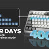 A close-up of a silver mechanical keyboard showing battery level indicators and text promoting long battery life.