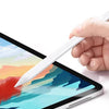 A hand holds a white stylus pen drawing on a digital tablet screen displaying colorful abstract painting layers.