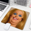 A realistic doll face design on a mouse pad featuring blonde hair and blue eyes