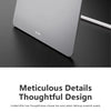 A close-up view of a silver foldable magnetic tablet stand with a circular cutout on a dark surface.