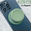 Olive green silicone cover for a MagSafe phone grip stand on a dark blue smartphone.