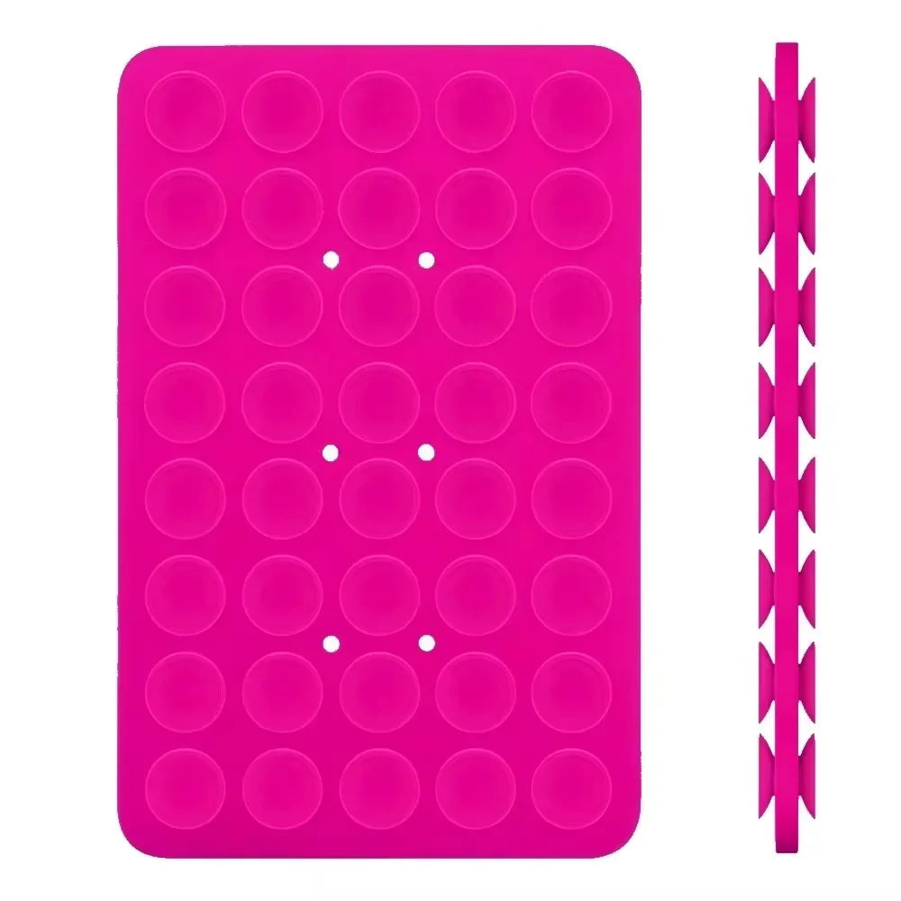 A pink double-sided silicone phone mount grip with multiple circular holes.