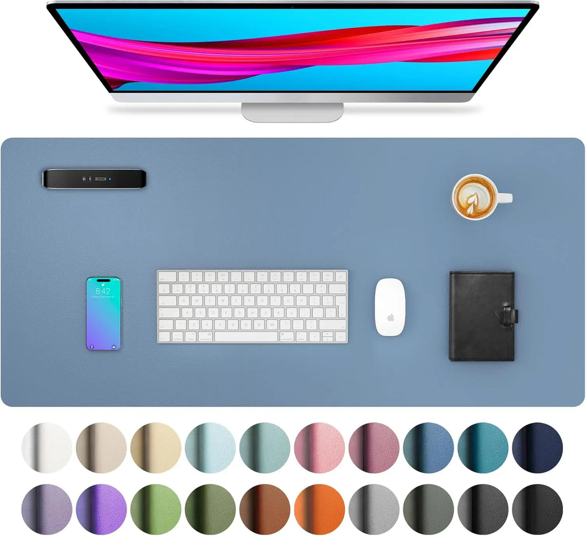 A large PU leather desk mat is shown with a computer monitor, keyboard, mouse, and smartphone on a light blue surface.