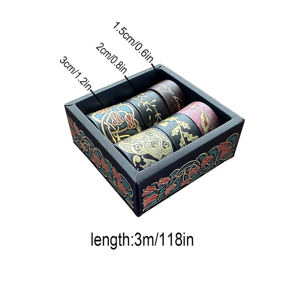A rectangular box containing a set of metallic gold washi tape rolls for journaling and crafts.