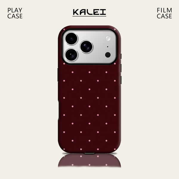 A dark maroon phone case with a repeating pink polka dot pattern shown in Play Case and Film Case versions.