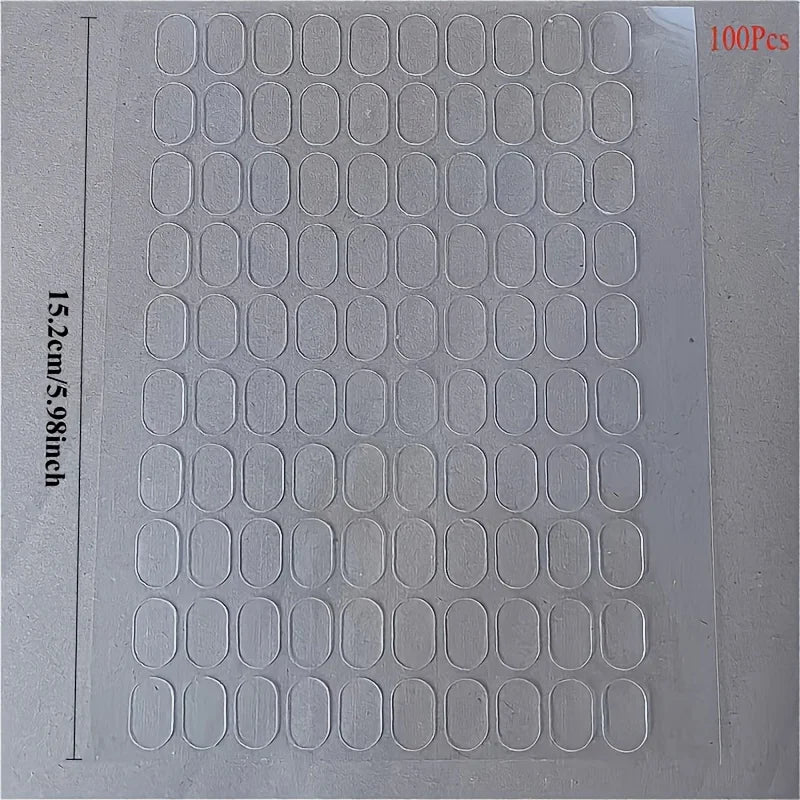 A sheet of transparent double-sided mounting tape with 100 pieces, measuring 15.2 cm by 5.98 inches.