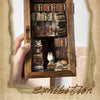 A wooden box displaying retro 3D relief book gallery stickers and small hand account mechanisms.
