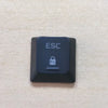 A black electronic device labeled ESC with a lock icon and a button on a light beige surface.