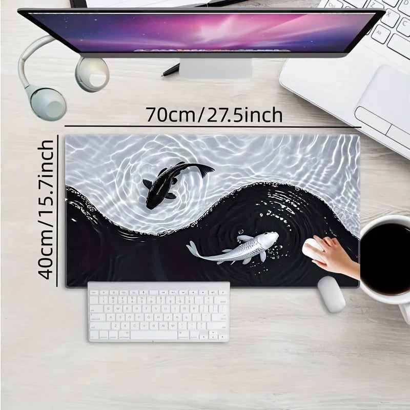 A gaming mouse pad featuring a black and white koi fish pattern placed on a wooden desk next to a laptop.