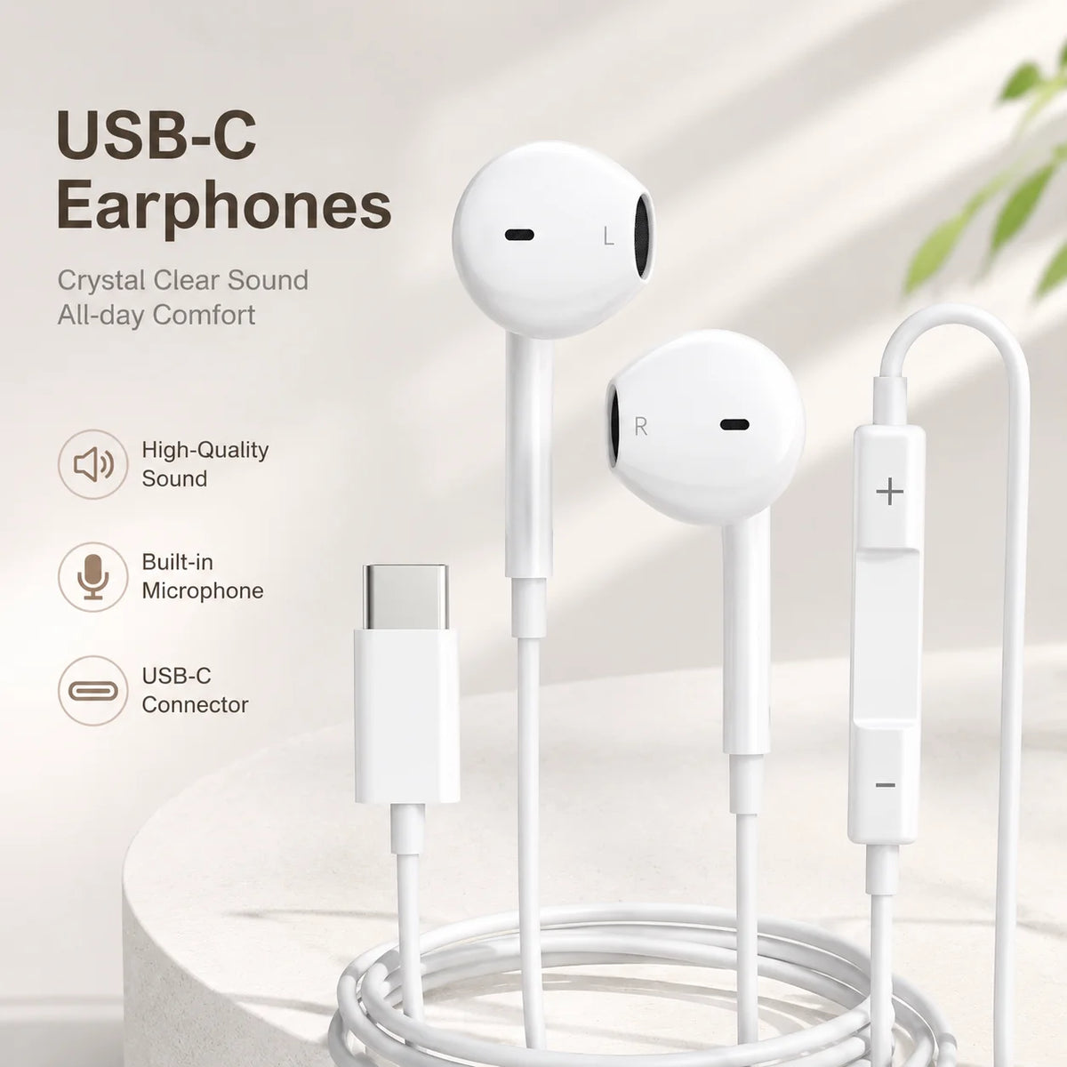 White USB-C earphones with a coiled cable and separate microphone components displayed on a white surface.