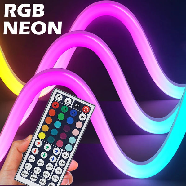 A hand holds a multi-color flexible neon LED strip light, displaying various colors on a control panel against a dark backgro