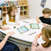 A group of children are using an incentive reward chart for behavior tracking on a table.
