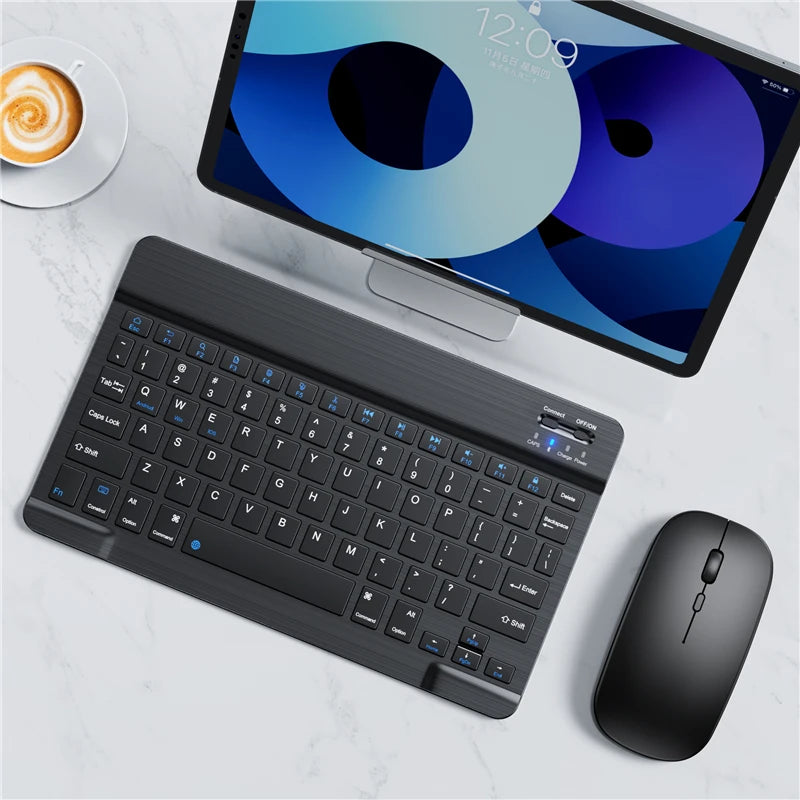 A black portable Bluetooth keyboard is shown next to an iPad displaying a blue and purple graphic.