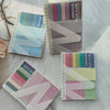 A collection of colorful A6 sticky note notebooks with loop closures and various pastel shades.