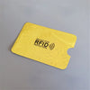 A yellow RFID protection card holder is shown on a gray surface.