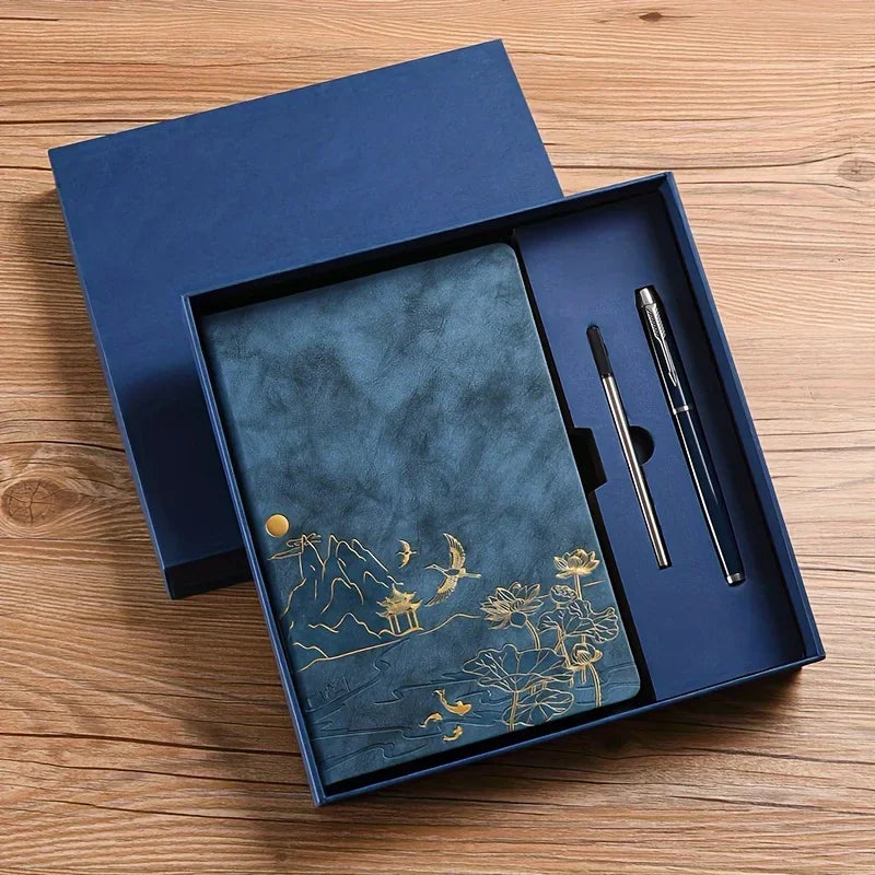 A dark blue luxury PU leather notebook set with gold foil decorative elements displayed in a wooden box.