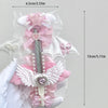 Pink and white intricate cat claw angel wing art knife cutter with decorative ribbons and pearl accents
