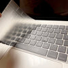 A close-up view of an Ultra-Thin TPU keyboard cover for a MacBook, showing the translucent silicone keys.