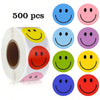 A roll of 500 smiling face paper stickers in various colors including blue, pink, and yellow.