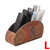 A PU leather remote control holder with five compartments is shown, containing a smartphone and a white remote.