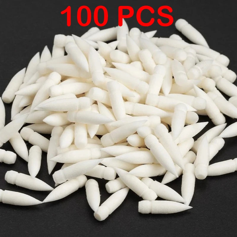 100 pieces of white acrylic art markers scattered on a dark surface
