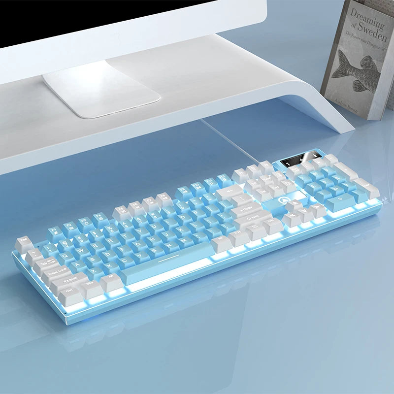 A light blue low profile wired gaming keyboard with a full numeric keypad is shown on a smooth surface.