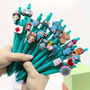A hand holds a bundle of medical theme ballpoint pens featuring various nurse and medical symbols.