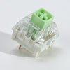 A close-up view of a light green tactile clicky mechanical keyboard switch housing.